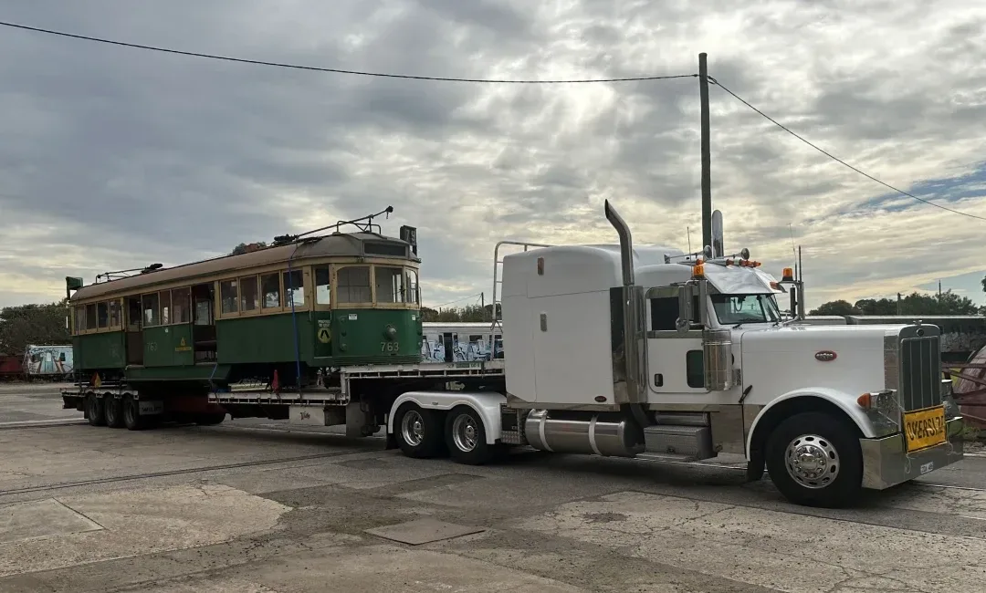Truck delivering a historic tram to country Victoria